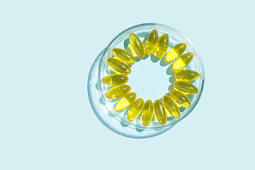 Omega3 gel capsule. Sun shadow. Yellow vitamin. Health eating. Dietology drug. Fish oil supplement. Nutritional concept. Golden softgel collagen. Medicine immunity cosmetics