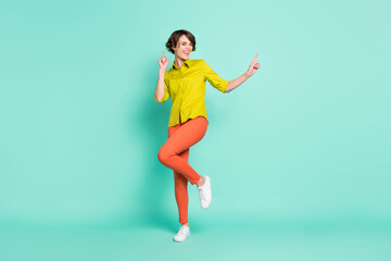 Fototapeta na wymiar Full length body size photo of dancing overjoyed girl wearing casual clothes isolated vivid teal color background