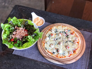 Top view of Fresh salad with tuna and pizza on white plate , Healthy food.