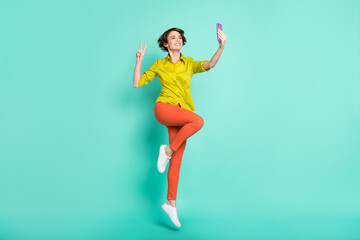 Fototapeta na wymiar Full length body size view of beautiful cheerful girl taking selfie showing v-sign wearing casual isolated on bright blue color background