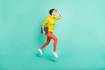 Full length body size view of attractive cheerful girl jumping carrying laptop finding way isolated on bright blue color background