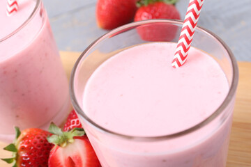 Delicious drink with strawberries on table, closeup