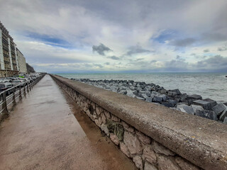 San Sebastian, Spain - Feb 1, 2021: Footpath following the coastline around San Sebastian's old town at the mouth of the Urumea river