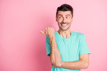 Photo of young excited man happy smile indicate finger empty space select advice ad isolated over...