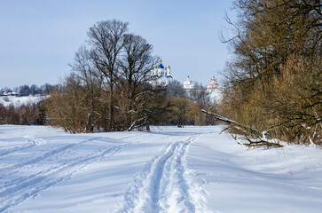 Cross-country skiing trails in Russia. Ski slope and on the hill there is a monastery