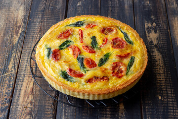 Quiche or pie with tomatoes, spinach and cheese. Healthy eating. Vegetarian food. French cuisine.