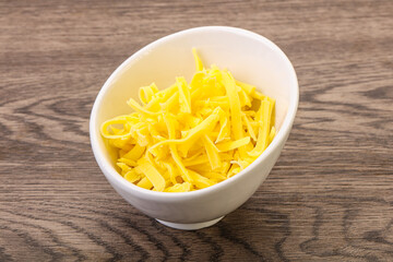 Shredded yellow cheese in the bowl