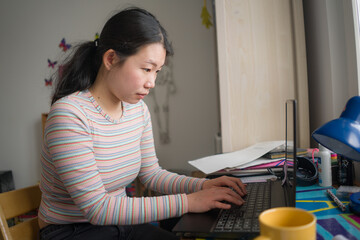 Fototapeta na wymiar telework and remote job - lifestyle portrait of young happy and beautiful Asian Chinese woman working on laptop or studying at home office focused and relaxed