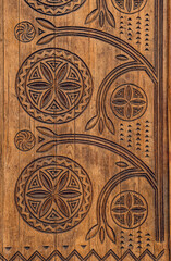 Fototapeta na wymiar Poltava, Ukraine - April 14, 2021: beautiful wooden door with a carved floral pattern in the Ukrainianhistorical building in the Ukrainian Art Nouveau style. Museum of Local Lore in Poltava, Ukraine