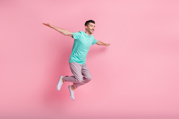 Fototapeta na wymiar Full size profile side photo of young man happy positive smile jump up hands wing fly isolated over pastel color background
