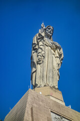 San Sebastian, Spain - April 2, 2021: The Sacred Heart statue and Castillo de la Mota, on Monte Urgull