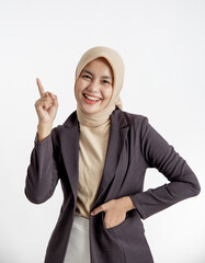 young businesswoman smiling pointing copy space, one hand in the suits pocket office work concept...