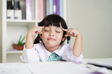 student child girl concentrate and focusing to the homework for elementary school. thinking for Educational solution concept.