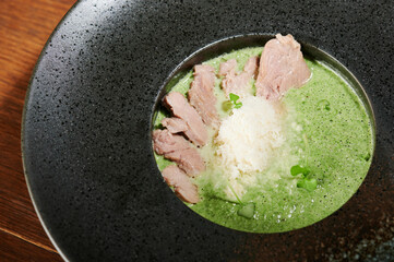 Green soup with meat and cheese