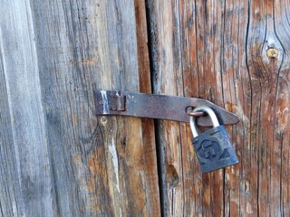 old padlock on a wooden door
