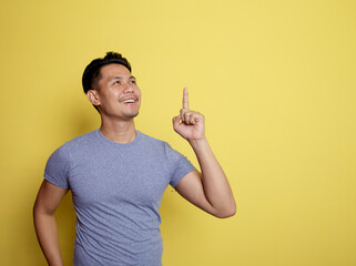 handsome man smile thingking idea isolated on a yellow color background