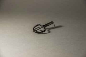 Jews' harp (Jews'-harp) in black colour on the gray solid backtroung with gradient.