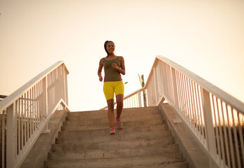 Fitness woman.  African woman jogging on the stairs.