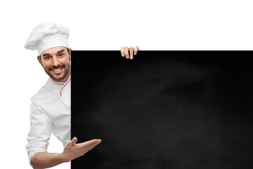 cooking, culinary and people concept - happy smiling male chef in toque with big black chalkboard...