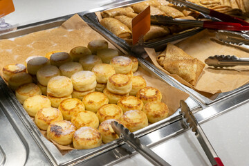 curd cakes, curd cakes, pancakes on the distribution line, self-service restaurant. Copispace