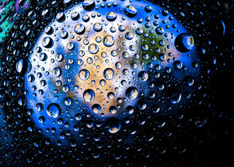 The planet earth inside a raindrops closeup. Soft focus. The world need refreshment concept and Environmental concept.