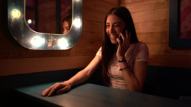 Closeup shot of a white Caucasian girl talking to the phone
