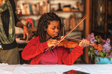 girl practicing and learning violin play at home  © august.columbo