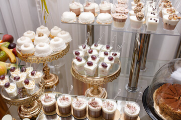 Wedding Candy Bar with a large three-story cake in a classic style. Table with sweets and desserts...