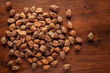 macro Close-up of Organic chana or chickpea (Cicer arietinum) or whole white Bengal gram dal cleaned on wooden top background.