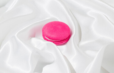 Creative background made with macaroon and white silk sheet. Minimal style composition.