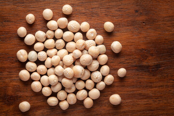 Macro Close up of Close up of Organic dry peas whole (Pisum sativum) or matar dal cleaned on wooden top background.