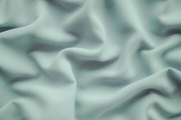 Obraz premium Green fabric cotton background. display abstract texture luxury cloth soft wave. for well use text present or promote your goods, products on free space background. top view or flat lay.