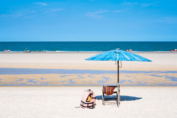 Tropical sea and beach with umbrella and deck chair wiht blue sky.Thai summer