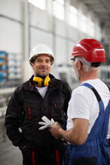  Portrait of workers in factory. Colleagues with helmet working in factory