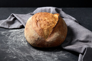 food, baking and cooking concept - homemade craft bread on table