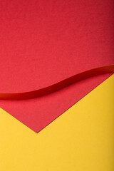 Abstract minimal paper background. Red cut out paper stripe on red and yellow paper background.