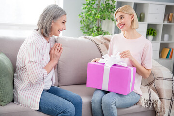 Photo of happy cheerful family expect gift box smile women day present sit sofa indoors inside house home