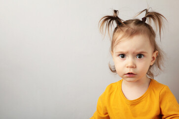 Naklejka premium Portrait of angry little girl on blue background with copy space