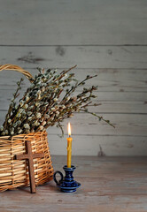 candle, cross and willow branches in wicker bascet. Palm Sunday symbol. Easter, faith, orthodox...