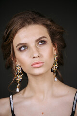 portrait of a model on a dark background with a bright make-up