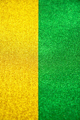 Abstract golden and green trendy backdrop. Bright holographic foil background. Colorful bright background. Flat lay