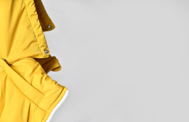 close-up of the hood from a yellow padded jacket. there is a place for your advertisement