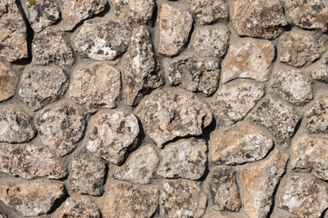 Decorative wall made of natural stone of various shapes and sizes. Interior background