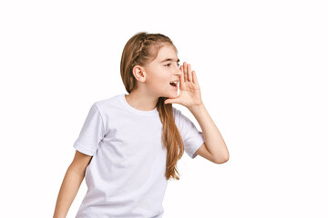 Fototapeta premium Children portrait in white t-shirt. Studio isolated concept. Shout rumor. Secret gossip. Modern communication. Girl hold hand near head