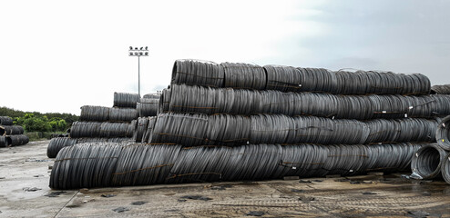 Stacked of high carbon wire rod for heavy industry production,Pile of metal steel wire roll for construction site, concrete usage and building construction