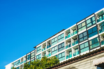 Obraz premium Modern low rise condominium residence against blue sky