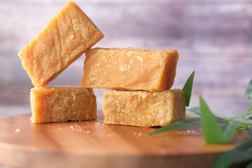 stack of Jaggery traditional cane sugar cube on table 