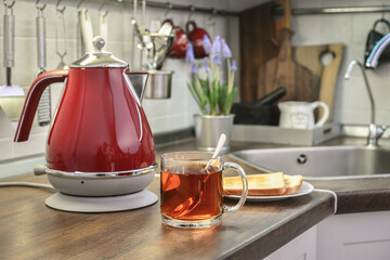 Red electric kettle and cap of tea