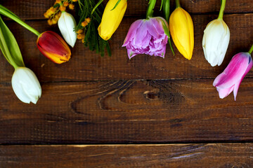 Spring flowers on wooden background with empty space. Background for greetings, invitations , and postcards.