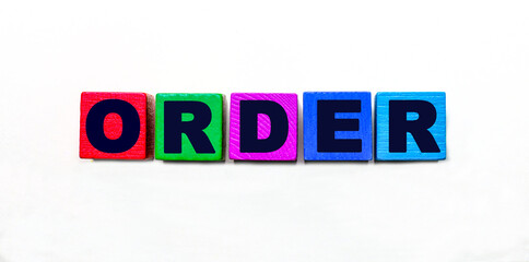 The word ORDER is written on colorful cubes on a light background